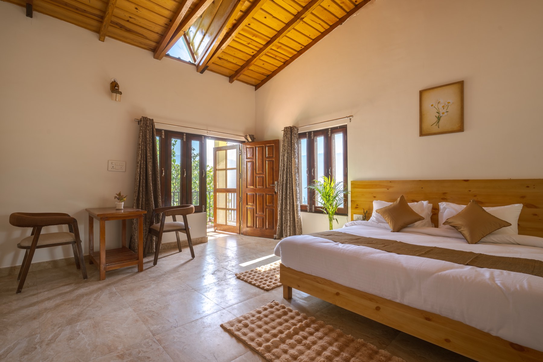 Spacious room with vaulted wood ceiling and mountain light